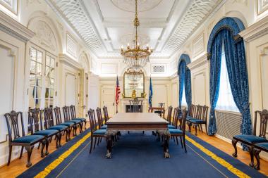 Spacious room with blue carpet and chairs