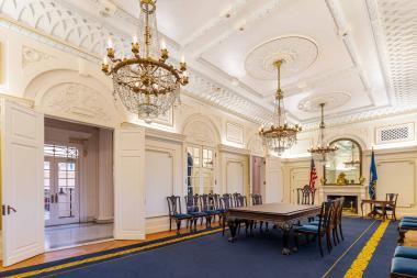 sophisticated room is decorated with beautiful furniture and a stunning chandelier