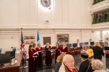 Carolers sing. 