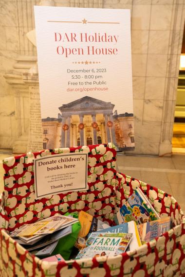 The DAR Open House sign and the donation box filled with books. 