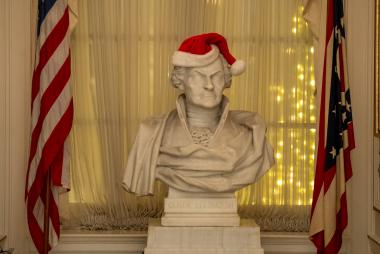 A bust with a Christmas hat on its head. 