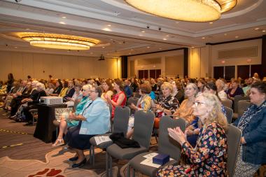 Women seated listening to a presentation 