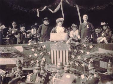 President General Cornelia Fairbanks officiates at the Memorial Continental Hall cornerstone laying ceremony. In front of her on the lectern is the actual cornerstone. The more than 50 items placed within it included a Bible belonging to a Revolutionary soldier, a copy of the Declaration of Independence, the American flag, the DAR insignia, portraits of the founders and the current issue of the daily newspapers.
