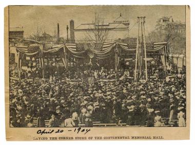 Hundreds of spectators gathered to witness the cornerstone laying, as shown in this photo that appeared the following day in a local newspaper. The Corcoran Gallery of Art is in the background in center. To the right is the Old Executive Office Building, now the office of the Vice President.