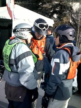 Volunteers talk a blind skiier through the process and equipment available.